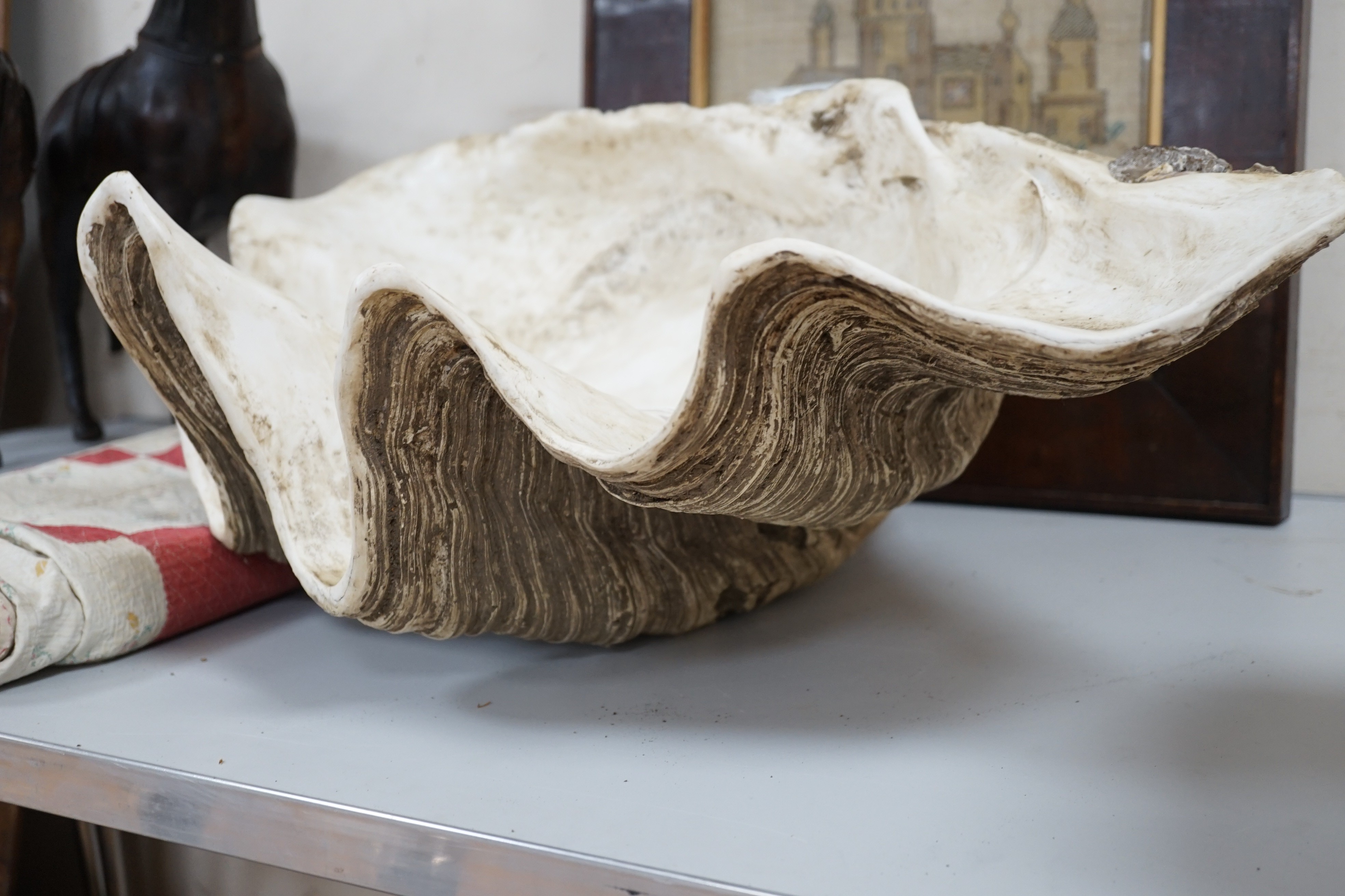 A large composite conch shell garden ornament, 72 cms wide
